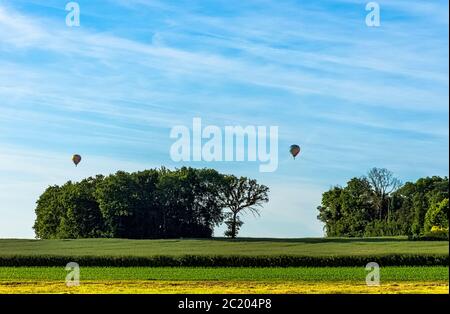 Hot air balloons over French fields - Dinan, France Stock Photo