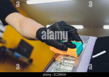 Car detailing - Man applies nano protective coating to the car. Selective focus Stock Photo