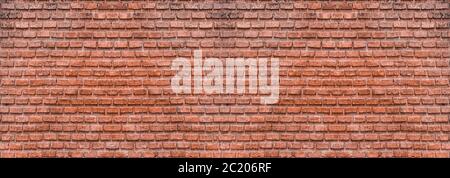 Dark brown old bricks wall panorama. Abstract brick texture for design or wallpaper. Stock Photo
