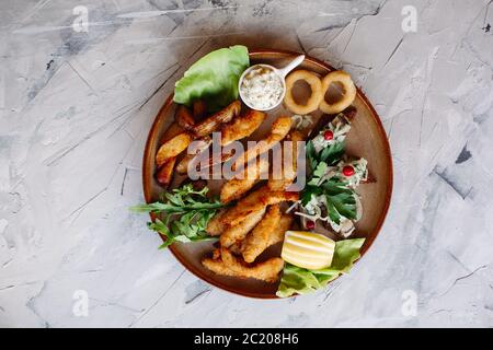 Clay plate full of delicious appetizers. Stock Photo