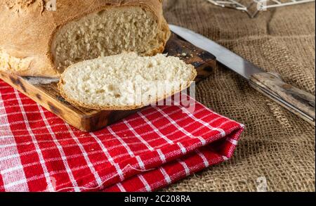Homemade bread. Homemade pastries. Breads on the kitchen table. Tasty and healthy. Fresh bread for vegetarians. Bread with wheat flour. Stock Photo