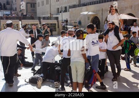 Jerusalem Israel May 14, 2018 Unknowns kids dancing front the Western wall in the old city of Jerusalem in the evening Stock Photo