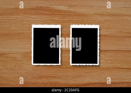 Top view of blank photo frames on wooden table background. Stock Photo