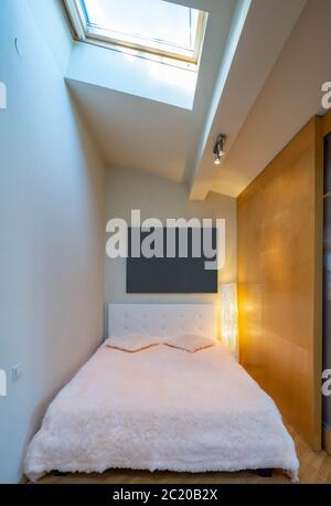 Small bed behind wooden sliding doors. Place for sleeping. Blurred picture. Stock Photo