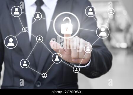 Businessman hand pressing unlock icon on virtual screen for network connection. Concept of global communication in business.