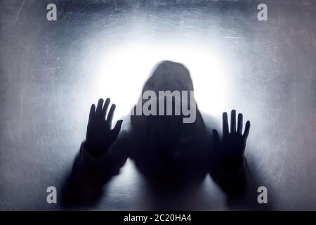 Ghostly figure behind a dusty scratched glass Stock Photo