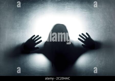 Ghostly figure behind a dusty scratched glass Stock Photo