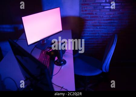 Condenser microphone on the table work and computer monitor equipment for the virtual meeting streaming online or conference working from home concept Stock Photo