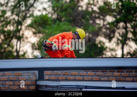 Mechanic in uniform, safety at work, roof, building Stock Photo