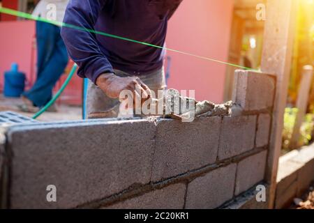Techniques for cement masonry for the construction of building fences Stock Photo