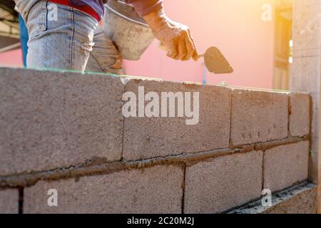 Bricklayer working on the construction of the wall or walls of the building. Stock Photo