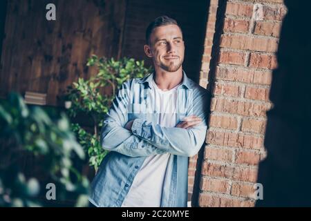 Photo of handsome homey guy leaning brick design wall look window dreamy imagination flight want go out arms crossed stay home quarantine time weekend Stock Photo