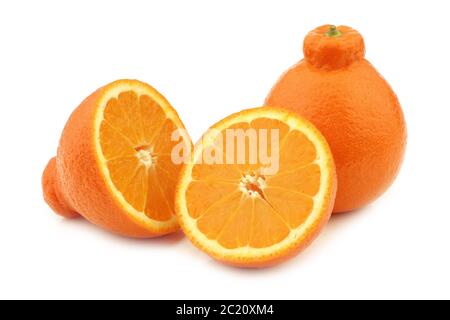 one fresh minneola and a cut one on a white background Stock Photo