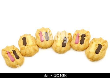 freshly baked decorated cookies with chocolate dressing on a white background Stock Photo