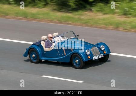 FX66FHO 2016 blue Morgan two seater  4/4 classic sports cars driving vehicle on UK roads, motors, leisure motoring on the M6 motorway Stock Photo