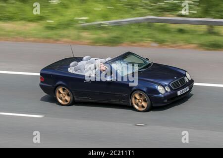 S5MVN 2000 Mercedes Clk 320 Elegance Auto Blue Car Cabriolet Petrol driving on the M6 motorway near Preston in Lancashire, UK Stock Photo