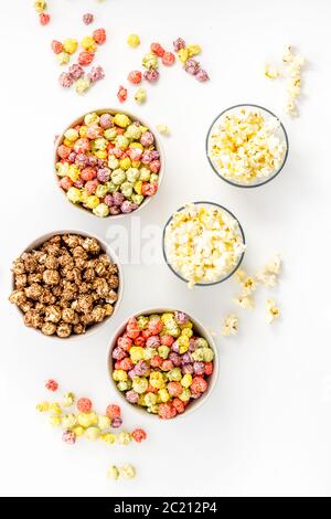 Flavored popcorn on white table top view Stock Photo