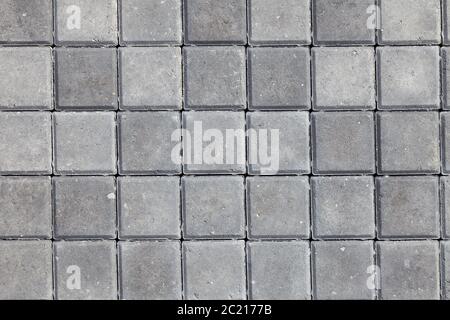Background and texture of gray color from square paving granite tiles. Decor of roads and pedestrian streets. Stock Photo
