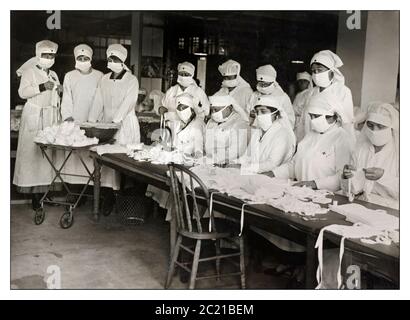 Mask Face Masks 1900s Spanish Flu mask Pandemic 1918 Red Cross volunteers making white (PPE) gauze face masks, which became mandatory in many public situations in the United States during the 1918 Spanish Influenza Pandemic Stock Photo
