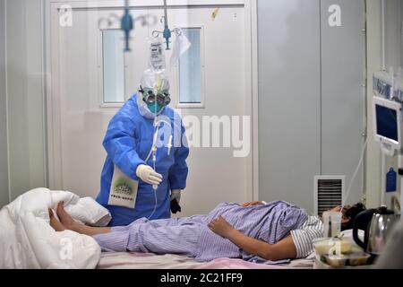 (200616) -- BEIJING, June 16, 2020 (Xinhua) -- A nurse treats a COVID-19 patient at an isolation ward in Beijing Ditan Hospital in Beijing, capital of China, June 16, 2020. Chinese health authority said Tuesday that it received reports of 40 new confirmed COVID-19 cases on the Chinese mainland Monday, of which 32 were domestically transmitted and eight were imported. Of the domestically transmitted cases, 27 were reported in Beijing, four in Hebei Province, and one in Sichuan Province, the National Health Commission said in its daily report. Right now, all the COVID-19 patients reported in Stock Photo