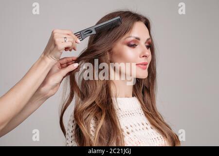 Elegant woman with makeup preparing for shooting in studio. Stock Photo