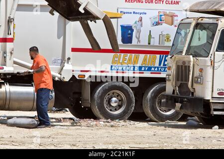 Clean Air vehicle 'Powered by Natural Gas', truck depositing garbage to local Sanitary Landfill, operator closing system. Stock Photo