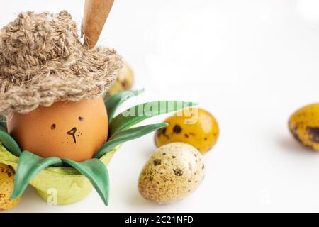 a hand made Easter Bunny in a village hat on the green grass Stock Photo