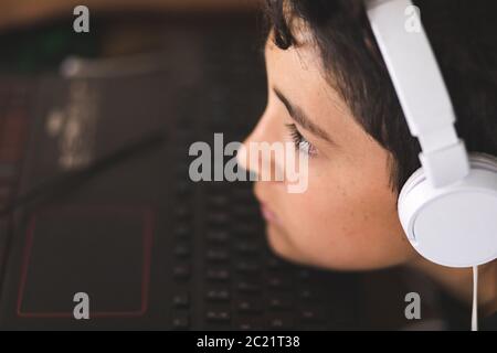 Boy doing his homework on laptop Stock Photo