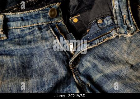 Grated jeans with a zip fastener and a button. Modern casual wear. Close-up. Front view. Stock Photo
