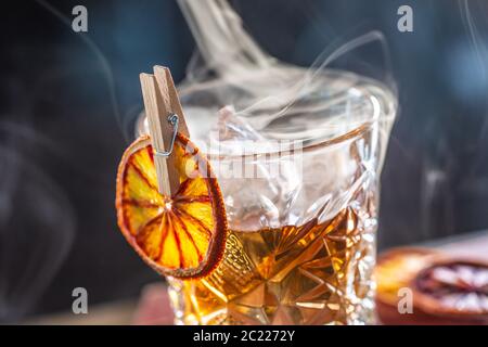 Detail of a smoked old fashioned rum cocktail Stock Photo