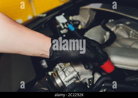 Cars in a carwash. Car wash with foam at station. Carwash. Washing at the station. Car washing concept. Car detailing. A man cleaning car. Worker clea Stock Photo