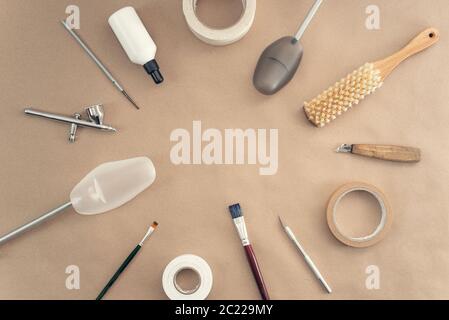 Tools for polishing, cleaning and repairing shoes on a craft background. Copy space Stock Photo