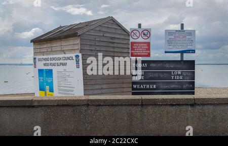 High and low tide information sign on entry to the beach. Shoeburyness, Southend on Sea, Essex Stock Photo