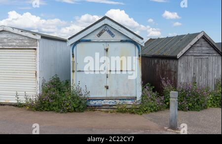 Three closed beach huts on a sunny day. Shoeburyness, Southend on Sea, Essex Stock Photo
