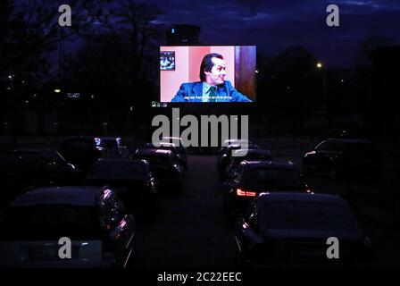 Linkoping, Sweden 20200425 Stanley Kubrick's 'The Shining' is shown at a drive-in cinema in central Linköping during Saturday night in these corona times. Staff on roller skates order candy and popcorn during the movie. Photo Jeppe Gustafsson Stock Photo