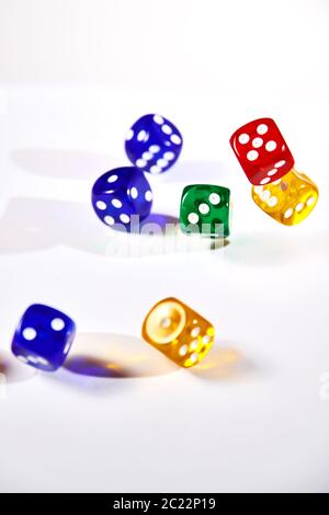 colorful dices in motion on white background Stock Photo