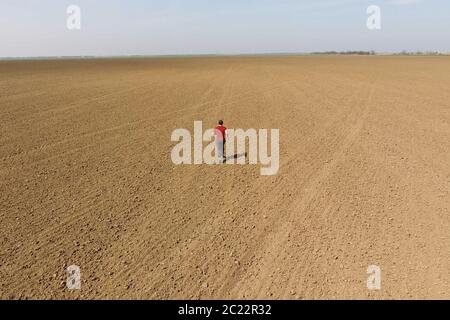 A man runs across the field. Jogging in the open field. Stock Photo