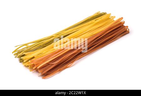 Uncooked multicolored  long ribbon pasta isolated on white Stock Photo