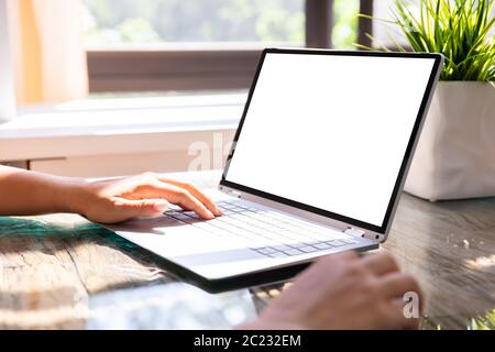 Close-up Of Businesswoman Working On Laptop With Empty Scree Stock Photo