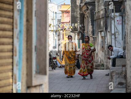 Somnath, Gujarat, India - December 2018:  Two Indian women wearing saris walking on the streets of the town. Stock Photo