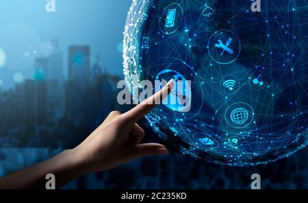 Female Hand Touching Holographic Globe Pushing Button On Blue Background Stock Photo