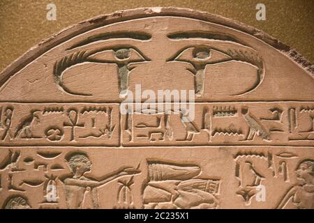 Leiden, The Netherlands - JAN 26, 2019: exhibition Gods of Egypt. Ancient Egypt hieroglyphics on a stela with two eye symbols on the top. Editorial im Stock Photo