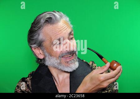 happy mature caucasian man smoking pipe Stock Photo