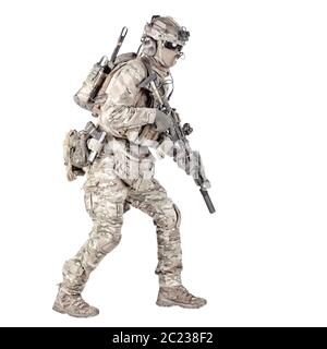 Army soldier, equipped infantryman, airsoft player in camouflage battle uniform, helmet and tactical radio headset jumping, running with assault rifle Stock Photo