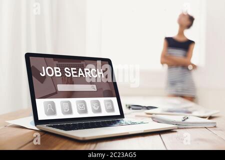 Laptop on the desk with job search engine on screen Stock Photo
