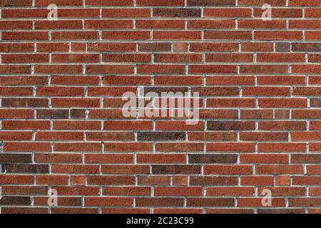 Long thin bricks in red and dark brown with a fine combed surface texture, creative copy space, horizontal aspect Stock Photo