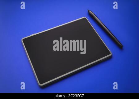 Graphics tablet Pen Touch on blue background Stock Photo