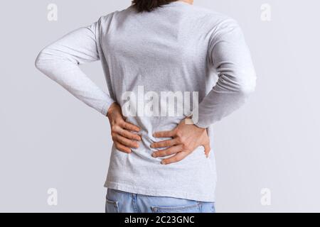 Renal colic and back pain. Man suffers from lower back pain Stock Photo