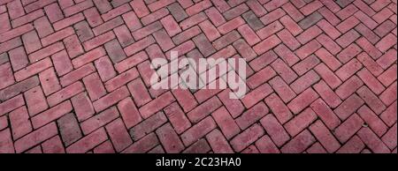 Perspective view background of bricks laid in a herringbone pattern, red brick in wide backdrop, horizontal aspect Stock Photo