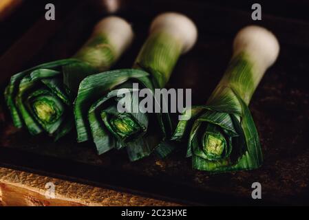 Fresh green leek stalks on metal tray Stock Photo